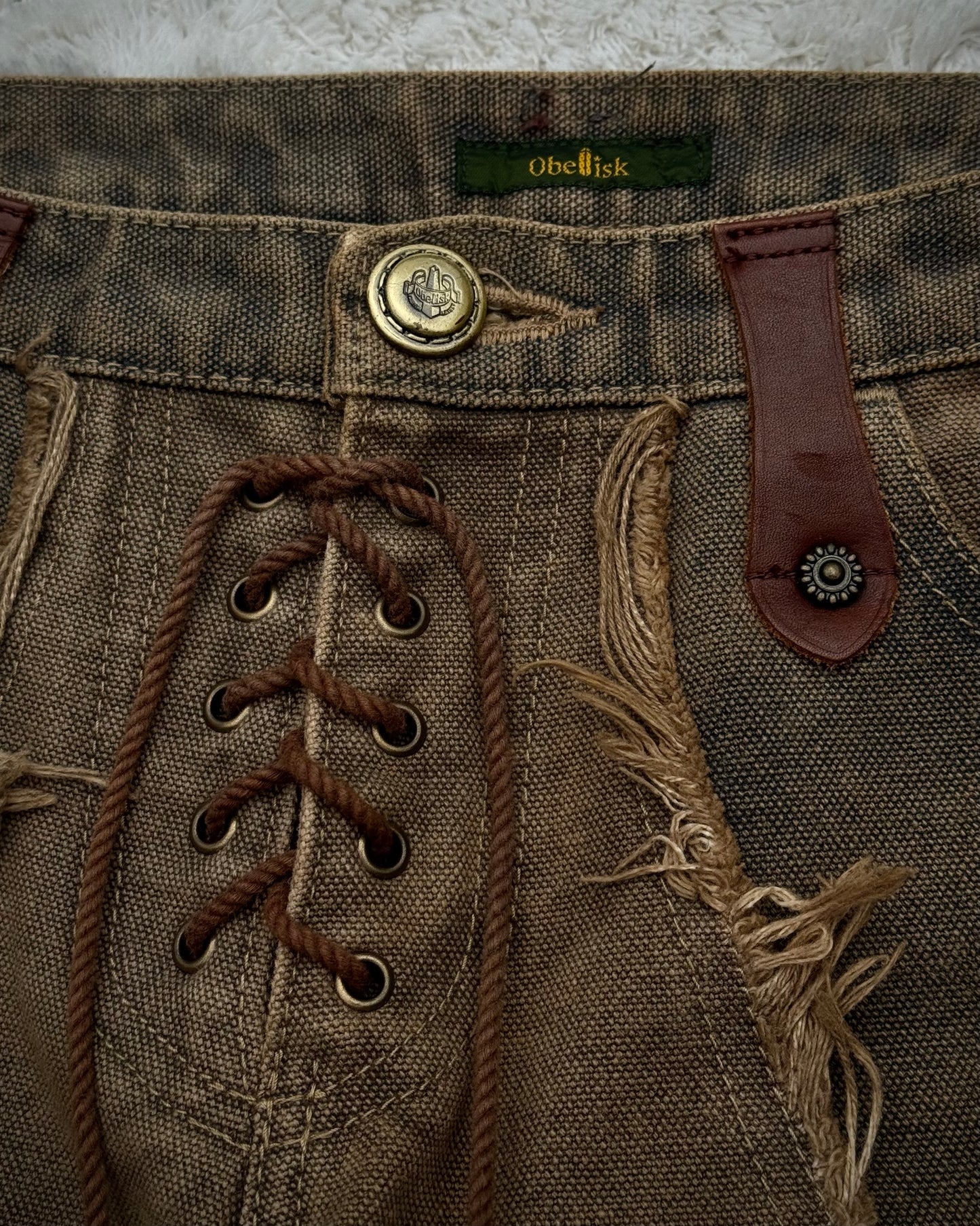 Obelisk Fringed Mud Washed Lace Up Flared Jeans